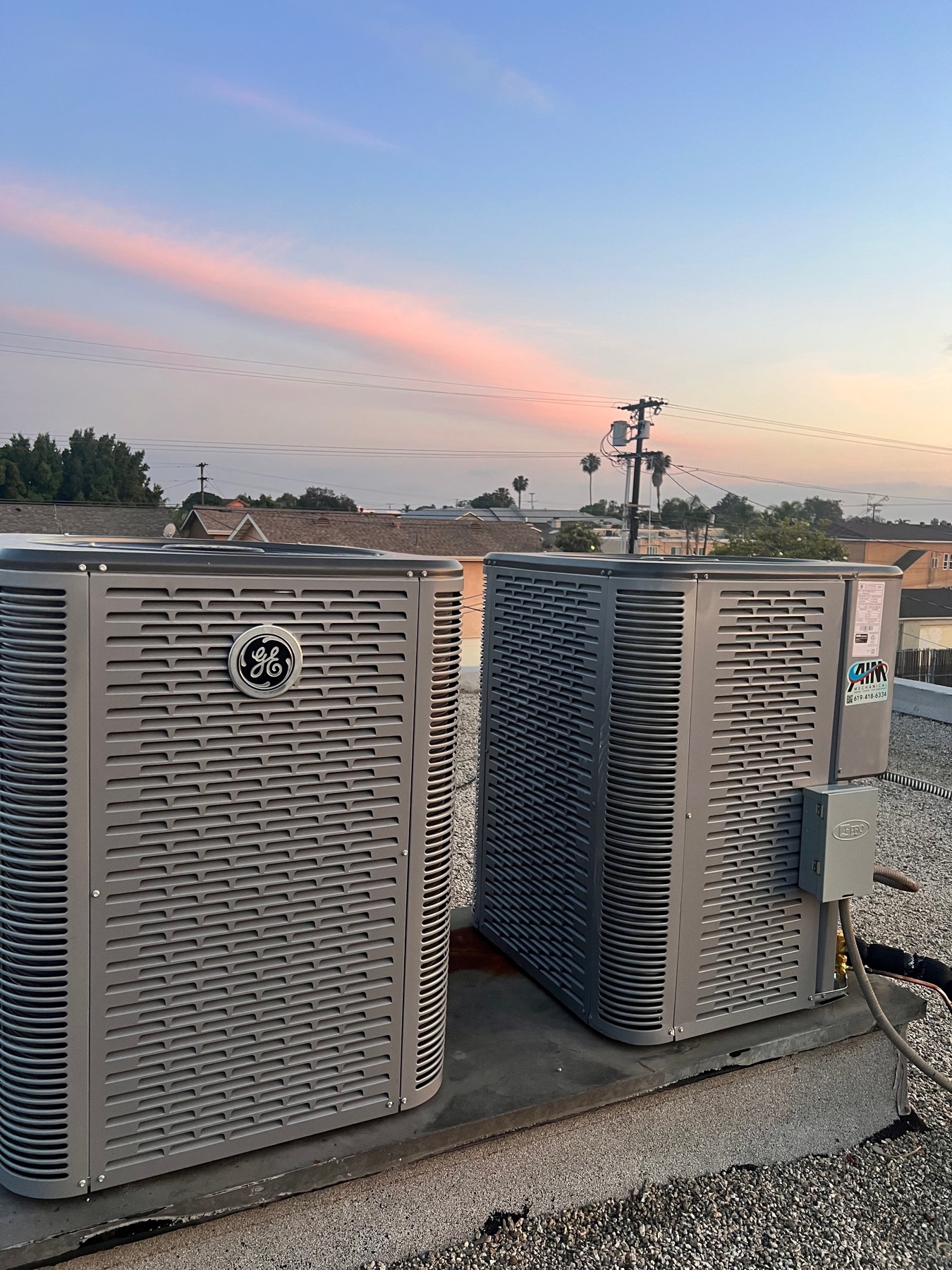 AIM Mechanical dual GE condenser installation on a San Diego rooftop at sunset