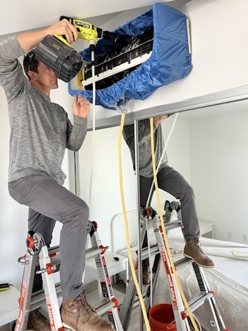 AIM Mechanical technicians cleaning an air duct and coil in San Diego